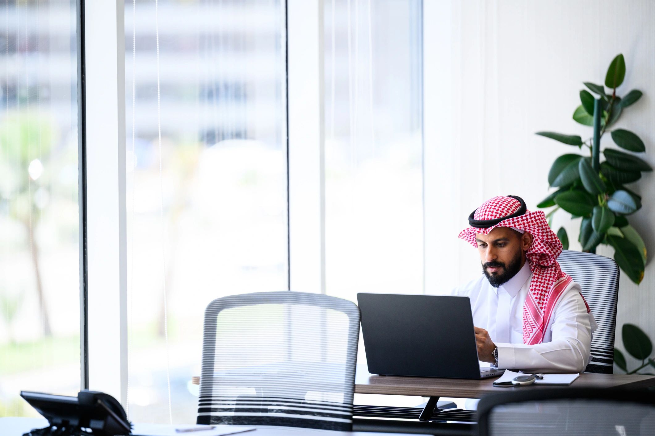Saudi business professional working in a modern office