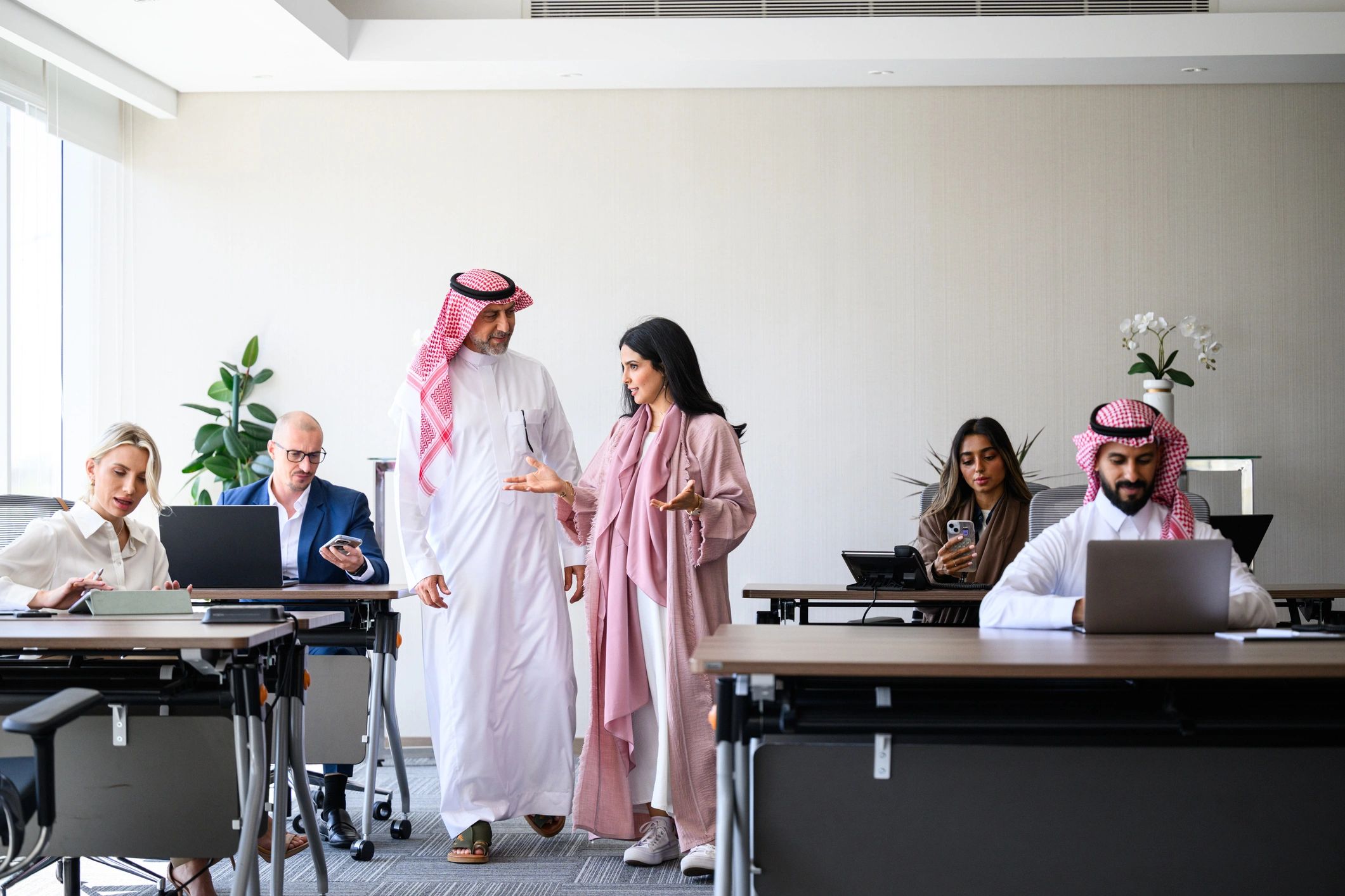 Multicultural business team collaborating in a modern Saudi corporate office
