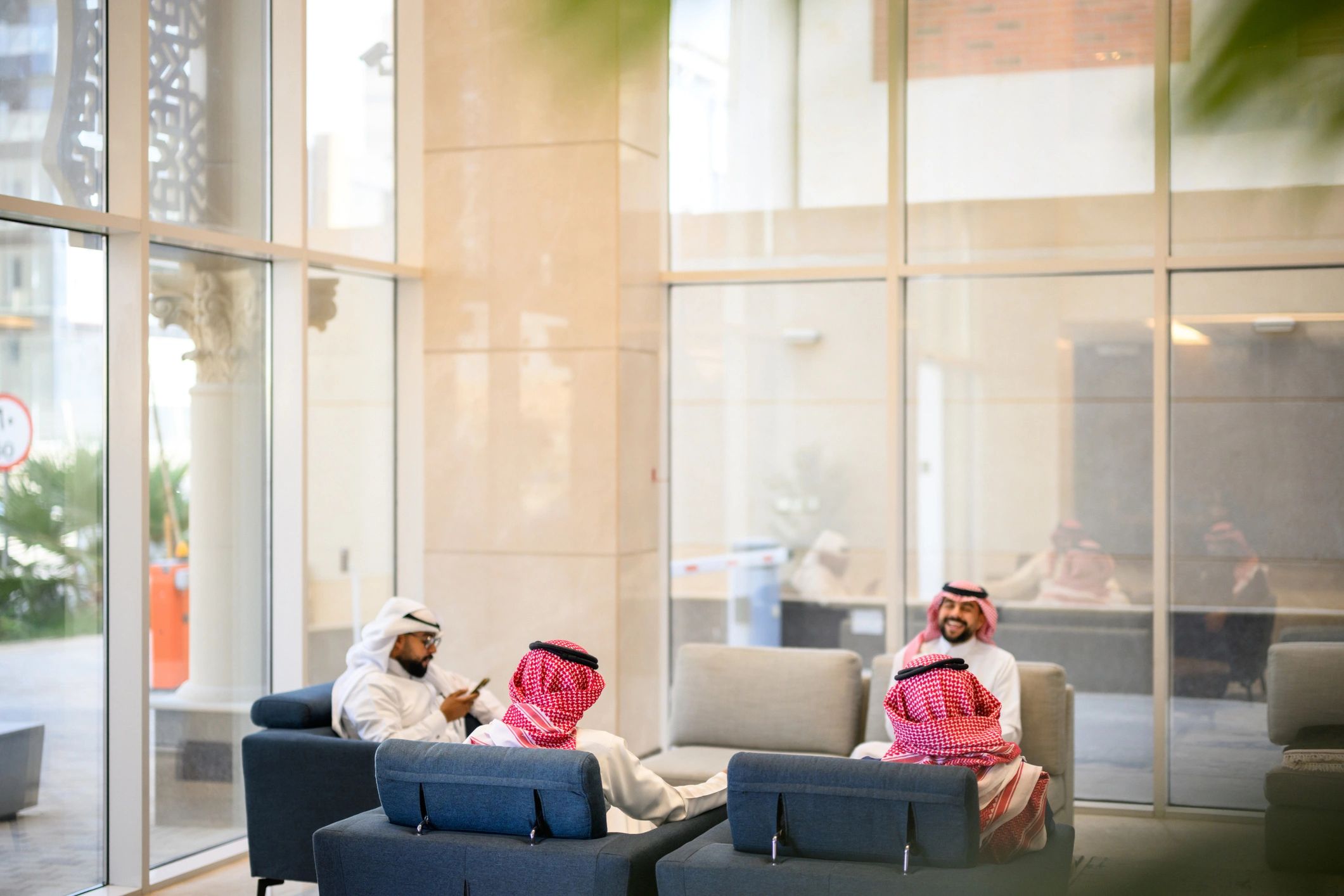 Saudi business professionals meeting in a modern lounge