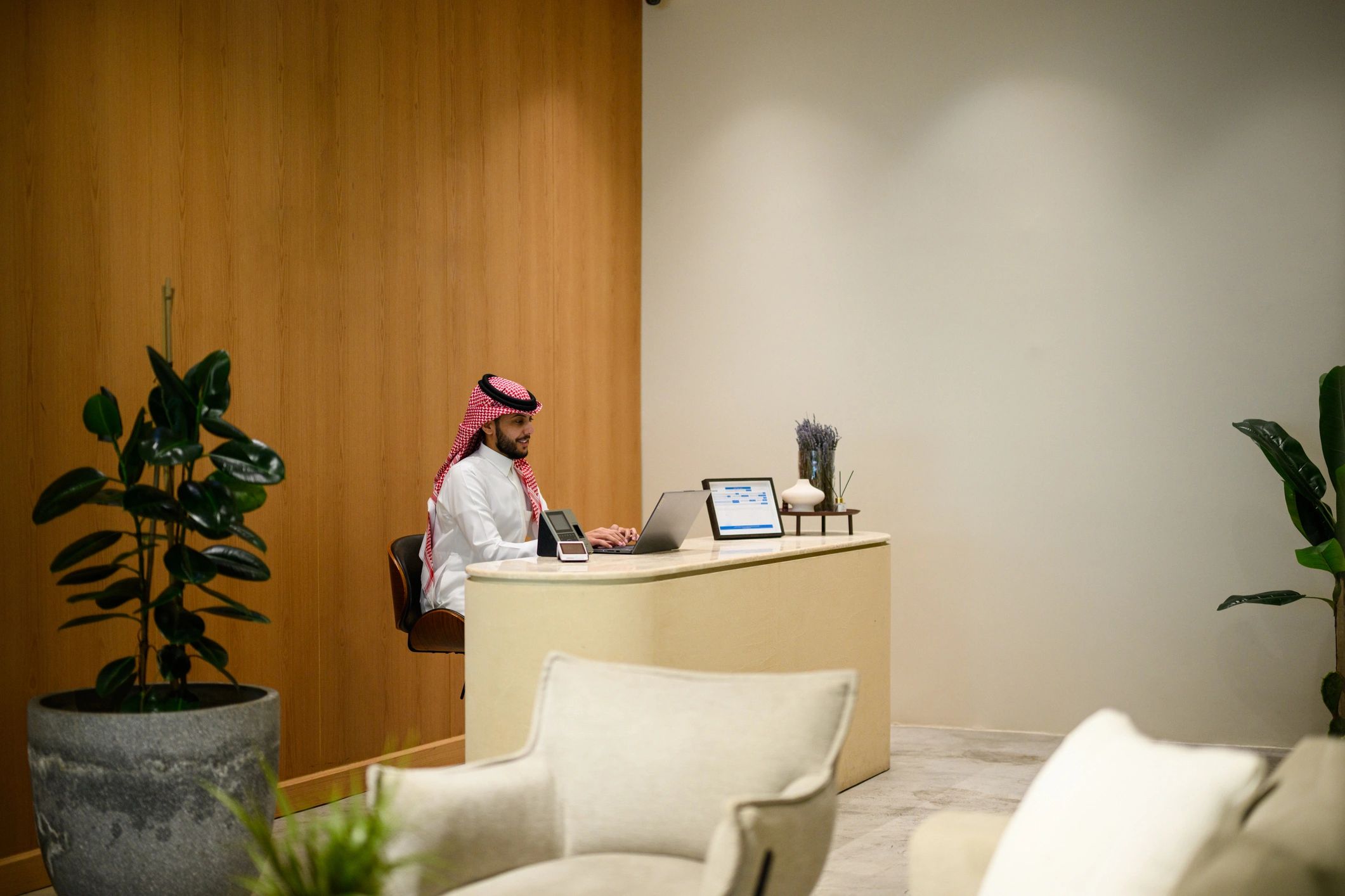 Saudi business professional in a modern office lobby
