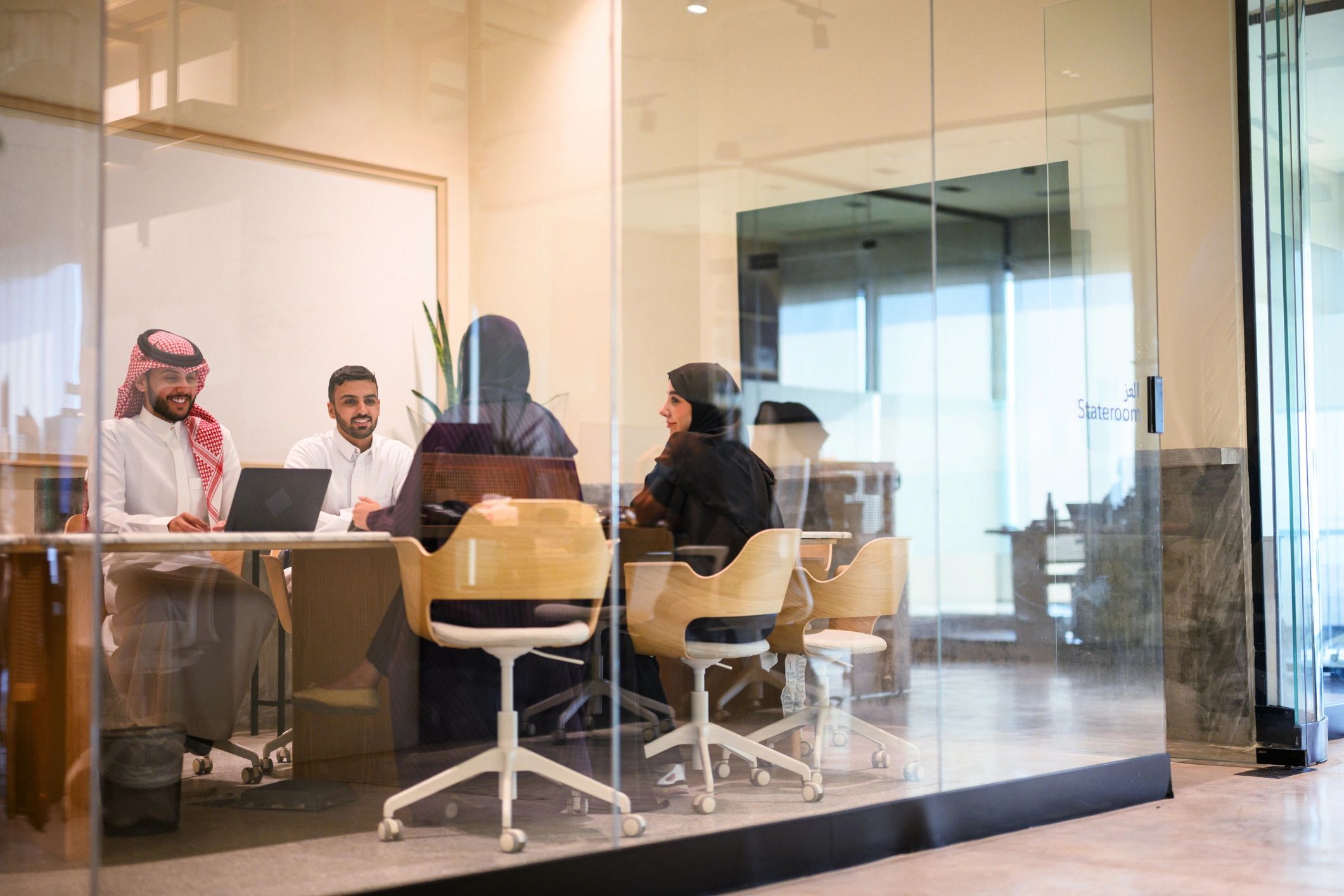 Saudi business team meeting in a contemporary office